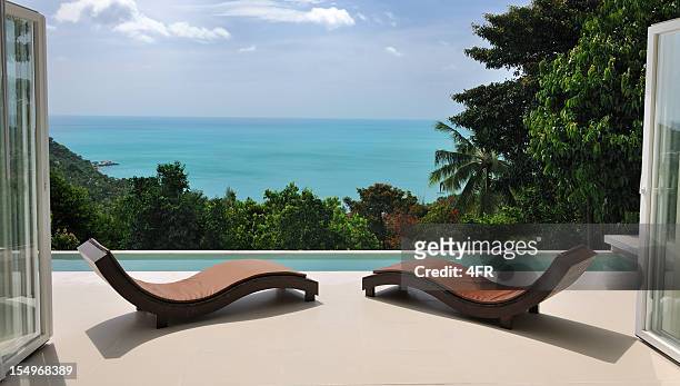 brown chaise lounges at private pool villa - upper class stock pictures, royalty-free photos & images
