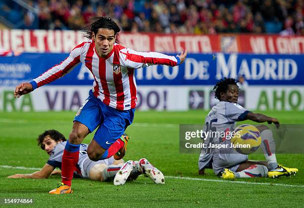 Falcao of Club Atletico de Madrid leaves Anthony Annan and Alejandro Arribas of Osasuna behind during the La Liga match between Club Atletico de...