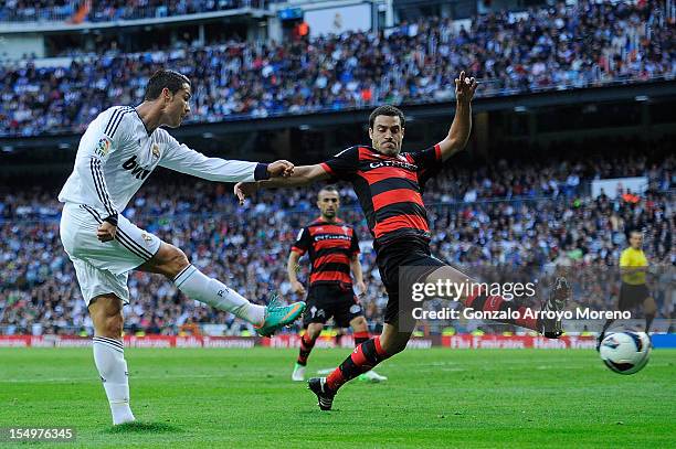 Cristiano Ronaldo of Real Madrid CF competes for the ball with Andres Jose Tunez of RC Celta de Vigo during the La Liga match between Real Madrid CF...