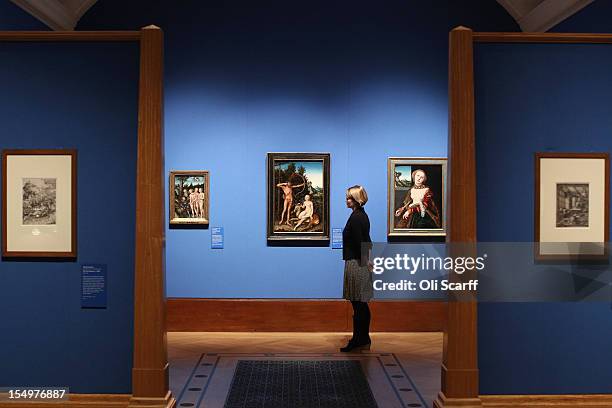 Woman admires paintings by Lucas Cranach the Elder in the exhibition 'The Northern Renaissance: Durer to Holbein' at The Queen's Gallery on October...