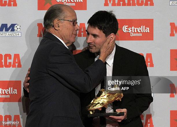 Barcelona's Argentinian forward Lionel Messi receives the European Golden Boot 2012 award for best European goalscorer of the 2011-2012 season by...