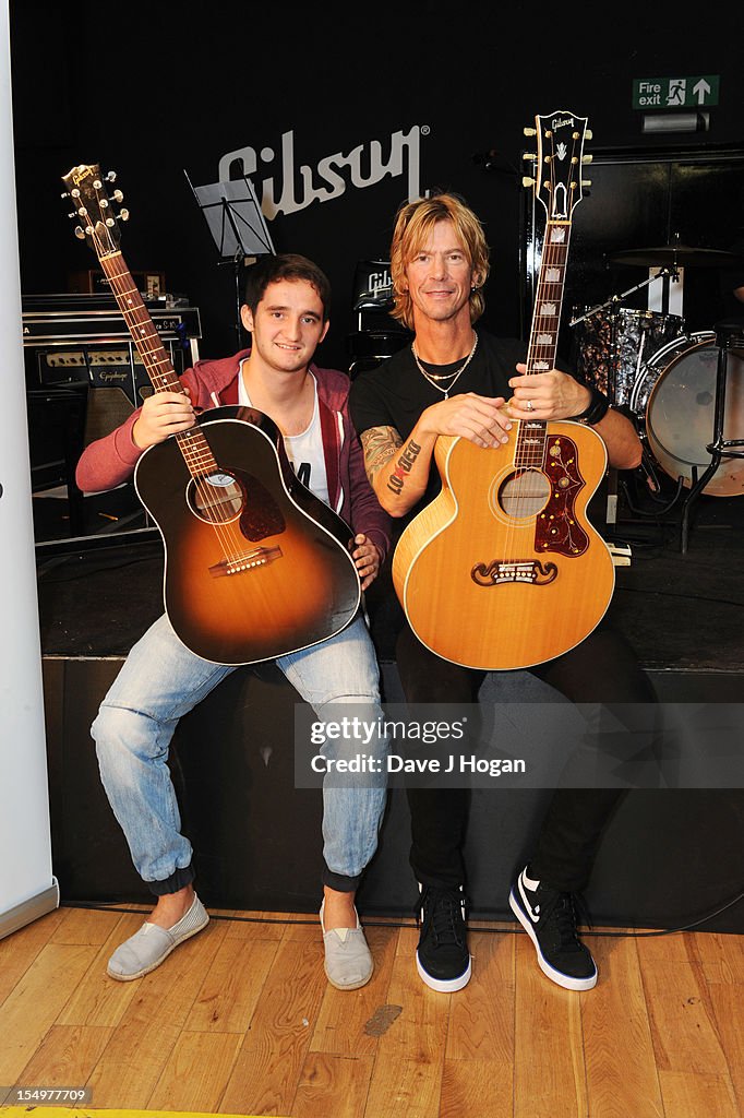 Duff McKagan poses with Help For Heroes Injured Soldiers At The Gibson Studio