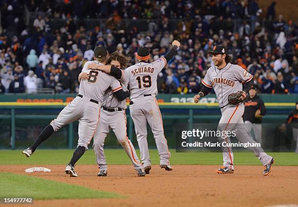 Hunter Pence, Ryan Theriot, Marco Scutaro and Brandon Crawford of the San Francisco Giants celebrate after the final out of Game Four of the World...