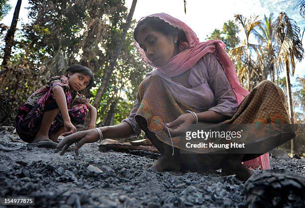 Muslim ladies collect metal pieces from the rubble of Muslim quarter in Pa Rein village, Myauk Oo township, that was burned in recent violence...
