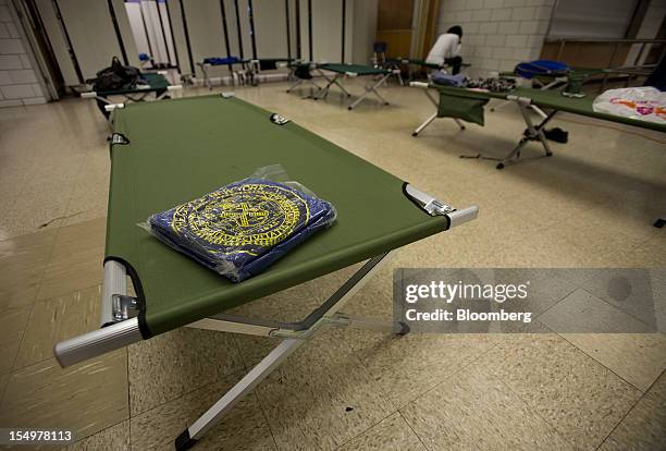 Cots and blankets are readied at a hurricane shelter in New York, U.S., on Monday, Oct. 29, 2012. Hurricane Sandy strengthened on its path toward New...