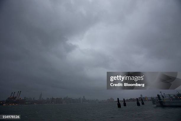 Storm clouds gather over the East River and Manhattan in New York, U.S., on Monday, Oct. 29, 2012. Hurricane Sandy strengthened on its path toward...