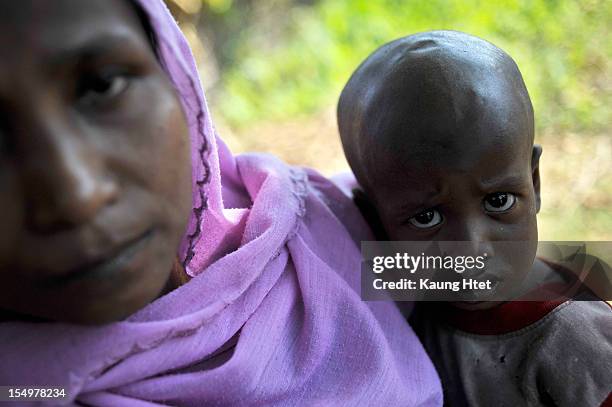 Muslim lady holds her child in Muslim quarter of Pa Rein village, Myauk Oo township on October 29, 2012 in Rakhine state, Myanmar. Over twenty...