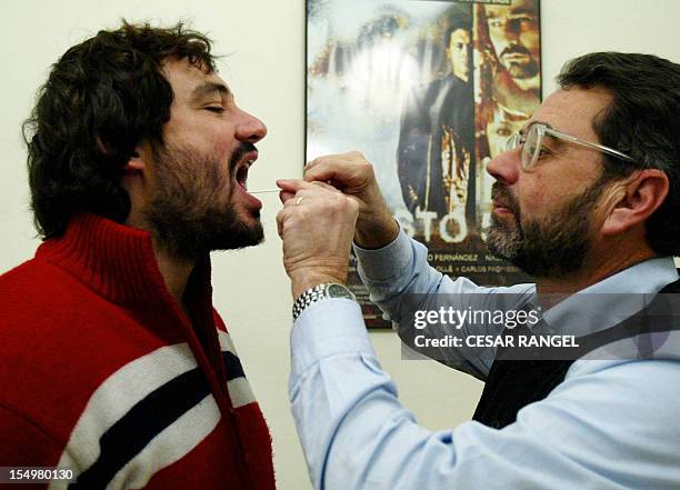 Genetic investigator Francesc Albardaner of the Colombins del Cultural Omnium takes a saliva sample from Jaume Colom Escayola to analyse his DNA in a...