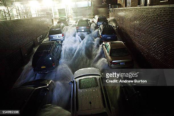 Rising water, caused by Hurricane Sandy, rushes into a subterranian parking garage on October 29 in the Financial District of New York, United...