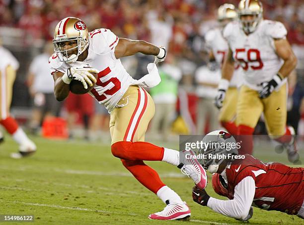 Receiver Michael Crabtree of the San Francisco 49ers slips out of the tackle of Patrick Peterson of the Arizona Cardinals after a catch during the...