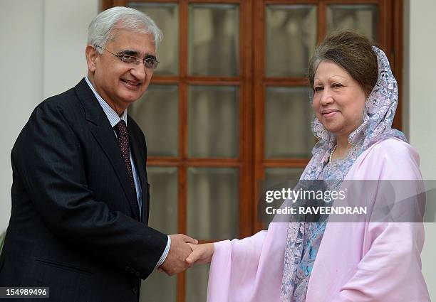 Indian Minister of Foreign Affairs, Salman Khurshid shakes hands with former Bangladesh President, leader of the Opposition and President of the...