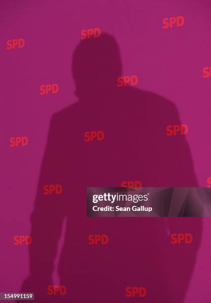 German Social Democrat and candidate for Chancellor Peer Steinbrueck casts a shadow as he speaks to the media to announce a full disclosure of his...