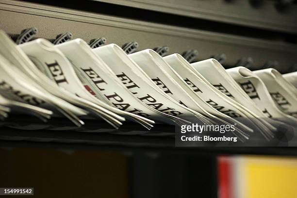 El Pais daily newspapers run through a conveyor after printing at the El Pais printing plant in Madrid, Spain, on Tuesday, Oct. 30, 2012. Prisa, the...