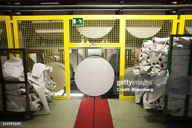 Rolls of newsprint paper sit in a warehouse at the El Pais printing plant in Madrid, Spain, on Tuesday, Oct. 30, 2012. Prisa, the publisher of El...