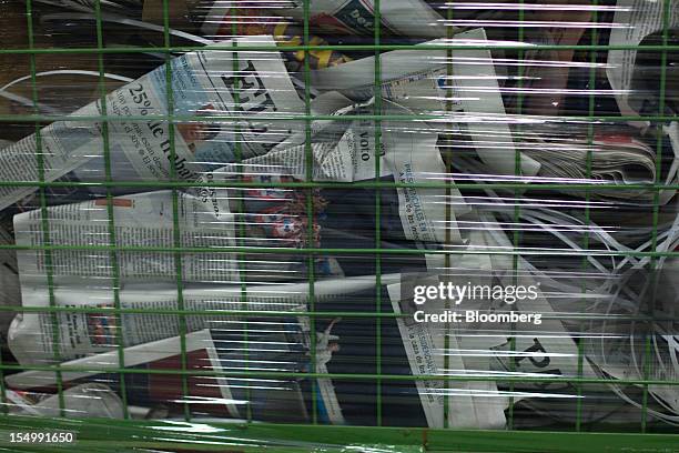 Trashed copies of recently printed El Pais newspapers lie in a basket at the El Pais printing plant in Madrid, Spain, on Tuesday, Oct. 30, 2012....