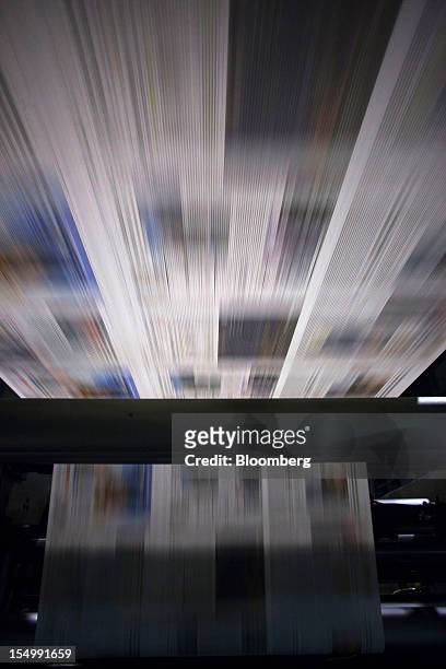 El Pais newspaper pages run through the printing presses at the El Pais printing plant in Madrid, Spain, on Tuesday, Oct. 30, 2012. Prisa, the...