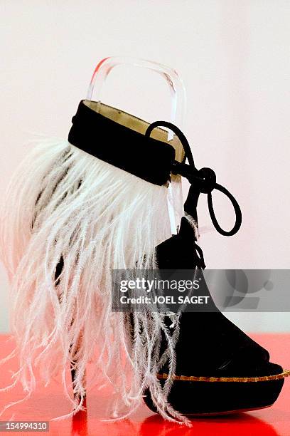 Picture taken on October 30, 2012 shows a 2012 "Andine" sandal with a bracelet by French shoe designer Eugene Riconneaus, displayed during the...