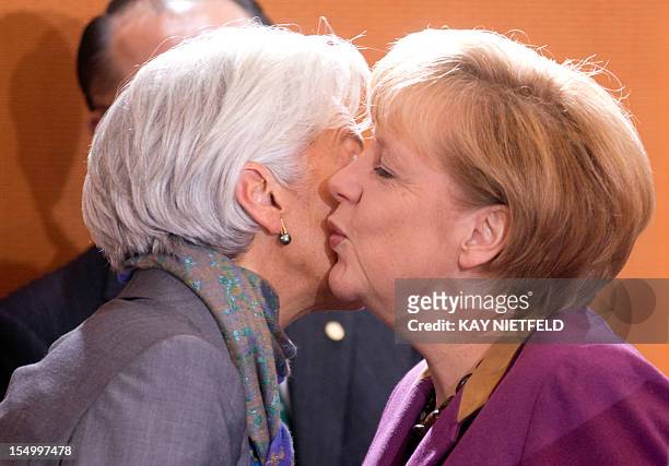 German Chancellor Angela Merkel welcomes Christine Lagarde, managing director of the International Monetary Fund , as she arrives for a meeting at...