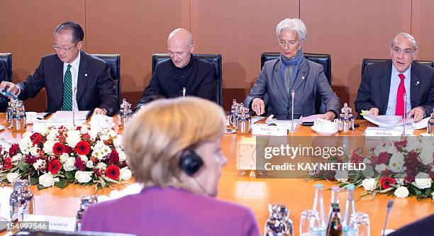 German Chancellor Angela Merkel and her guests Christine Lagarde , managing director of the International Monetary Fund , World Bank chief Jim Yong...