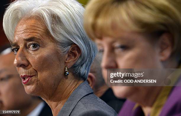 Christine Lagarde , managing director of the International Monetary Fund and German Chancellor Angela Merkel give a press conference following a...