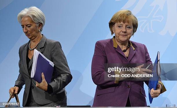 German Chancellor Angela Merkel and Christine Lagarde, managing director of the International Monetary Fund , leave after a press conference...