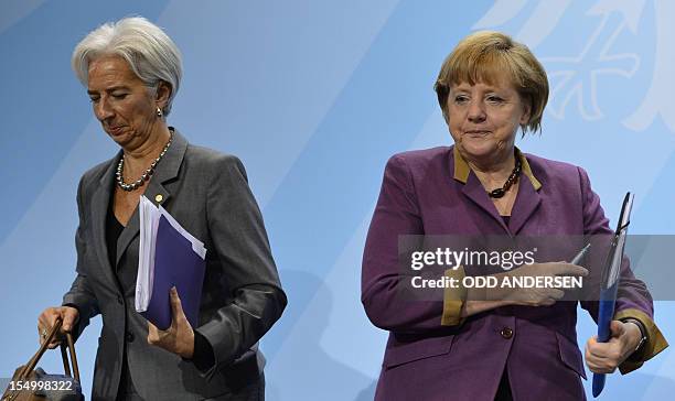 German Chancellor Angela Merkel and Christine Lagarde, managing director of the International Monetary Fund , leave after a press conference...