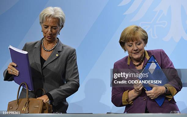 German Chancellor Angela Merkel and Christine Lagarde, managing director of the International Monetary Fund , leave after a press conference...