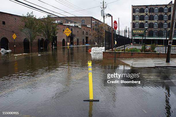 Water floods Van Brunt Street in the Red Hook neighborhood of the Brooklyn borough of New York, U.S., on Tuesday, Oct. 30, 2012. New York City...