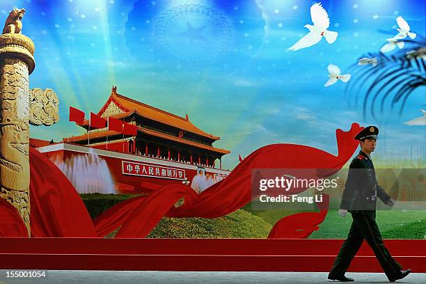 Paramilitary policeman patrols during an exhibition entitled "Scientific Development and Splendid Achievements" before the18th National Congress of...