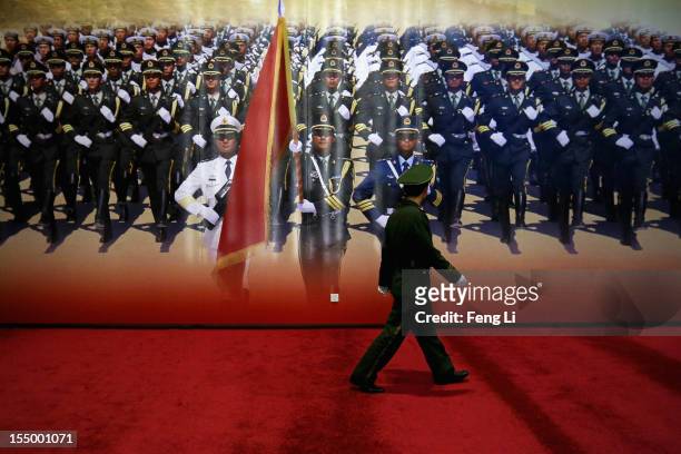 Paramilitary policeman patrols during an exhibition entitled "Scientific Development and Splendid Achievements" before the18th National Congress of...