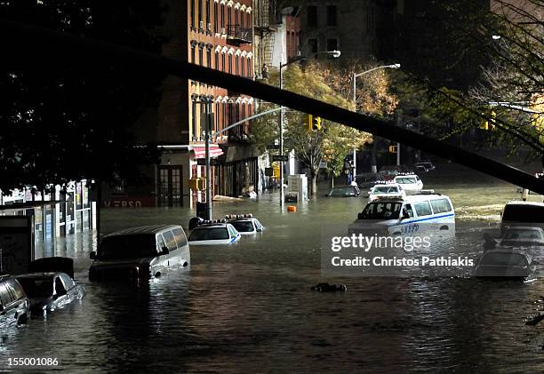 General view of submerged cars on Ave. C and 7th st, after severe flooding caused by Hurricane Sandy, on October 29, 2012 in Manhattan, New York. The...