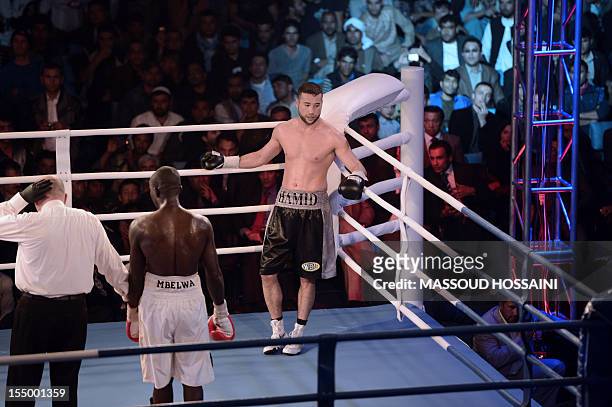 Afghan-German boxer Hamid Rahimi stands back during his fight with Tanzanian Said Mbelwa in Afghanistan's first professional bout in Kabul on October...