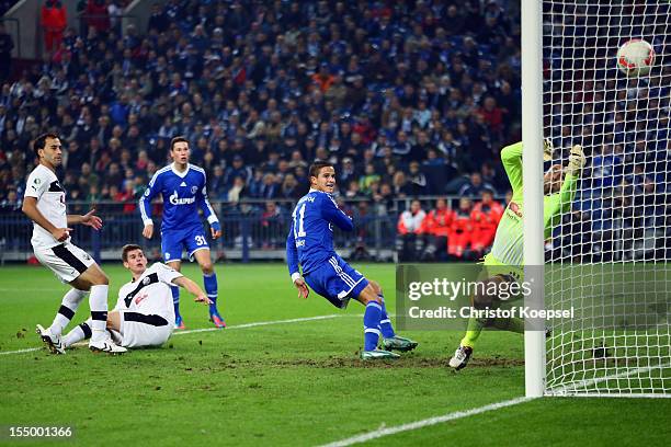 Ibrahim Affelay of Schalke scores the first goal against Daniel Ischdonat of Sandhausen during the DFB Cup second round match between FC Schalke 04...