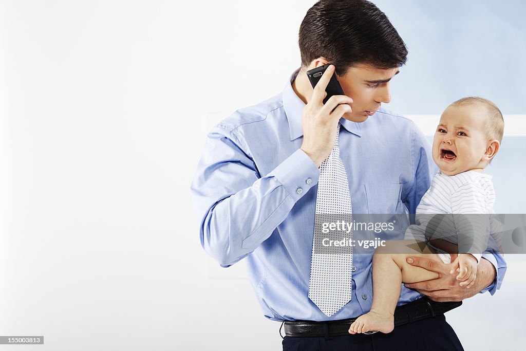 Businessman Father Holding Crying Baby