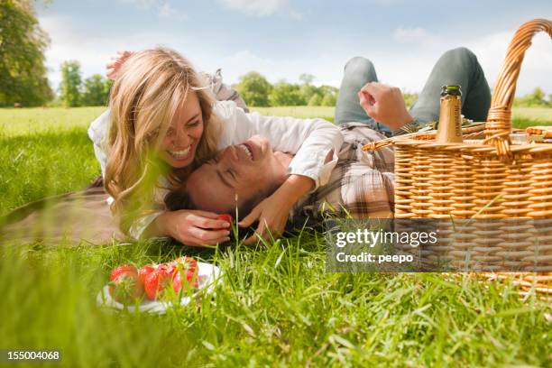 attractive couple having picnic - besparen stockfoto's en -beelden