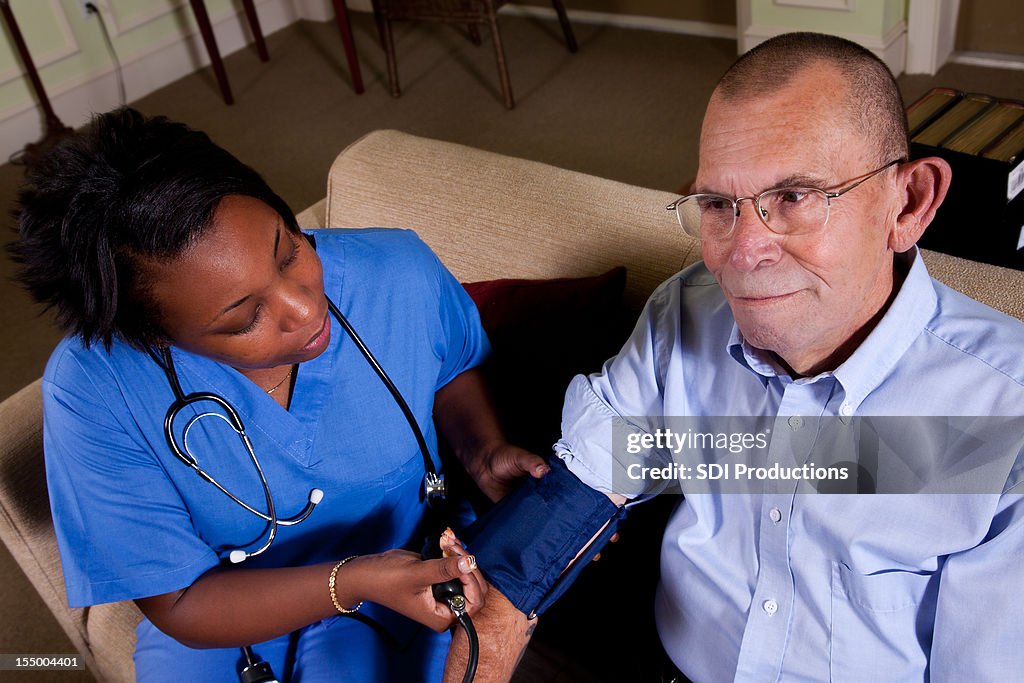 Healthcare Nurse Checking Heart Rate of Senior Adult Patient