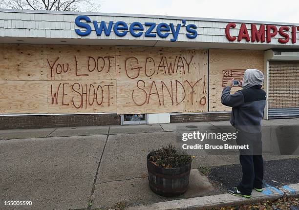 Sporting goods and camping store displays it's message to residents in the aftermath of Hurricane Sandy on October 30, 2012 in Huntington Station,...