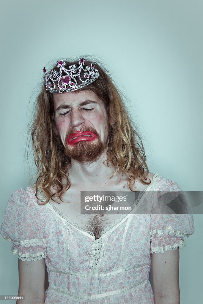 Crying man homecoming queen in drag tiara on head lipstick