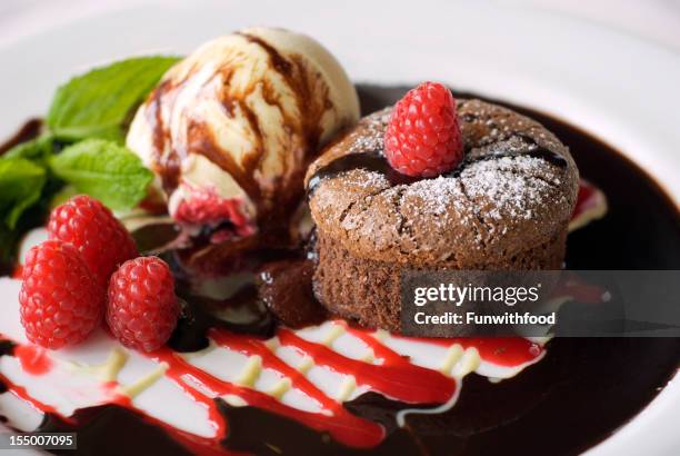 chocolate souffle cake, vanilla ice cream & raspberries - chocolate souffle stock pictures, royalty-free photos & images