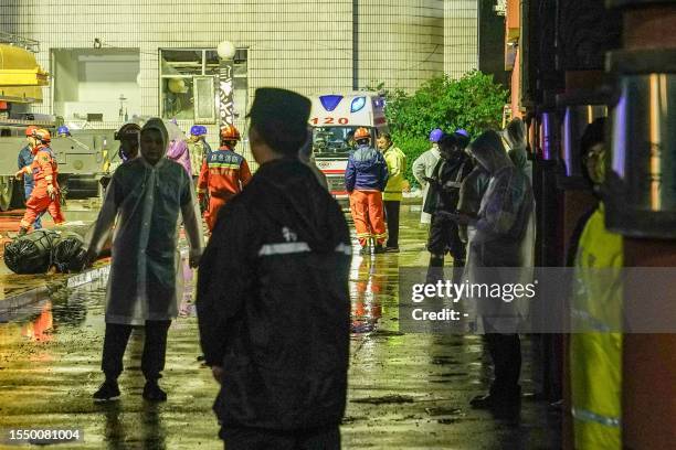 Rescuers work at a school gym after the roof of the building collapsed in Qiqihar, in China's northeastern Heilongjiang province early on July 24,...