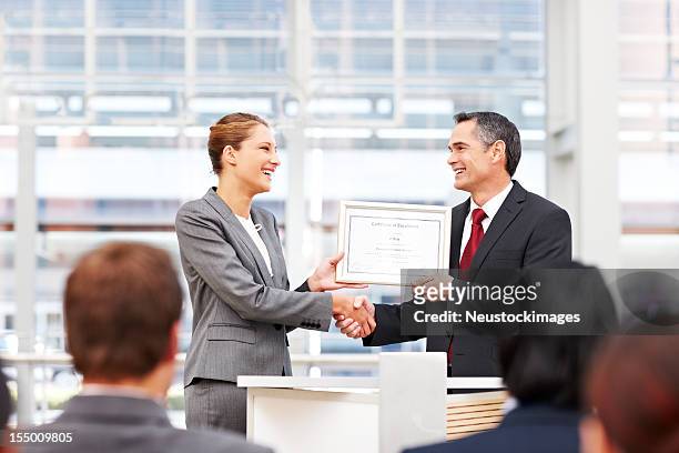 businesswoman receiving an award - awards ceremony stock pictures, royalty-free photos & images