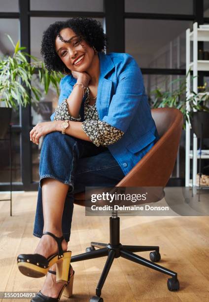 a woman sitting and smiling looking into the camera. stock photo - hand on knee stock pictures, royalty-free photos & images