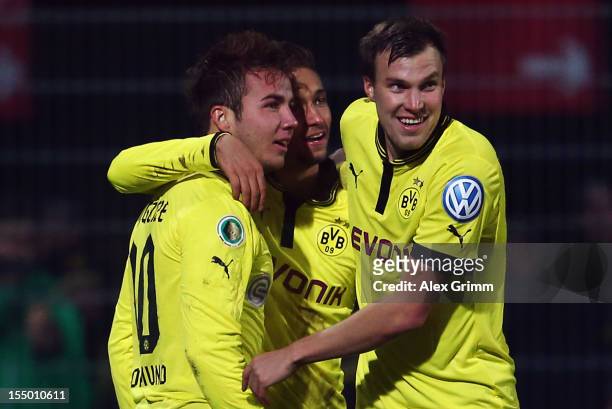 Mario Goetze of Dortmund celebrates his team's third goal with team mates Moritz Leitner and Kevin Grosskreutz during the second round match of the...