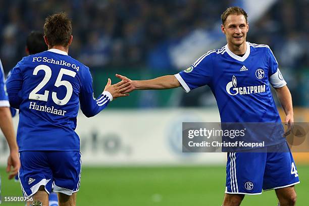 Klaas-Jan Huntelaar of Schalke celebrastes the third goal with Benedikt Hoewedes during the DFB Cup second round match between FC Schalke 04 and SV...