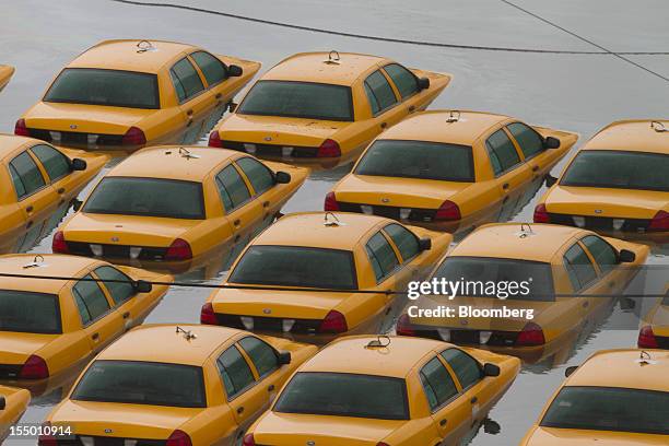 Fleet of taxis sits submerged in water in Hoboken, New Jersey, U.S., on Tuesday, Oct. 30, 2012. The Atlantic storm Sandy left a landscape of...