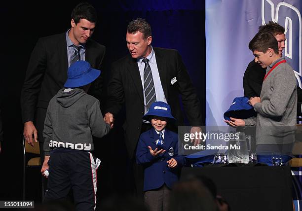 Anthony Boric and Coach Sir John Kirwan present young kids with hats during the 2013 Blues squad announcement at Eden Park on October 31, 2012 in...