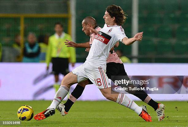 Egidio Arevalos Rios of Palermo and Riccardo Montolivo of Milan compete for the ball during the Serie A match between US Citta di Palermo and AC...