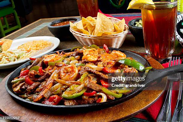 shrimp, beef and chicken mexican fajitas - fajita stock pictures, royalty-free photos & images