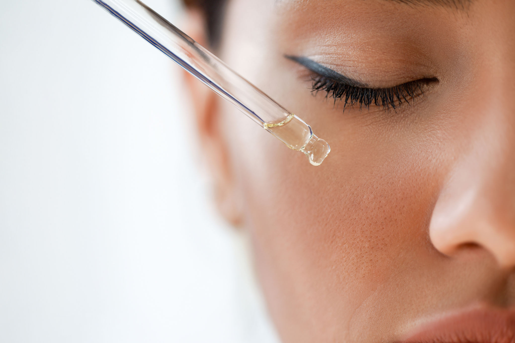 Woman applying essential oil Woman applying essential oil