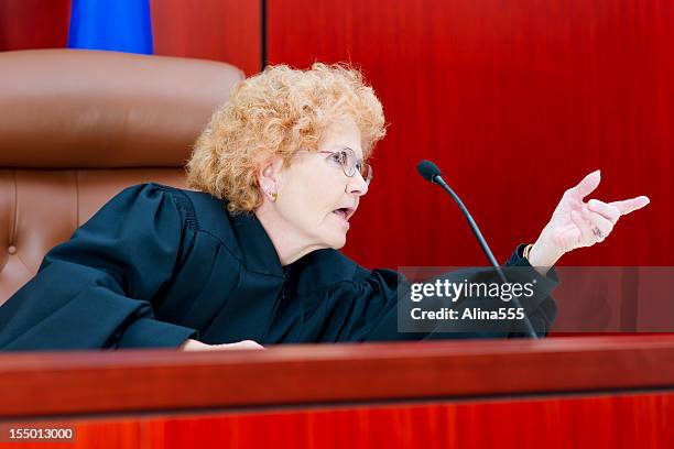 senior female judge at the bench with serious look - judge bench stock pictures, royalty-free photos & images